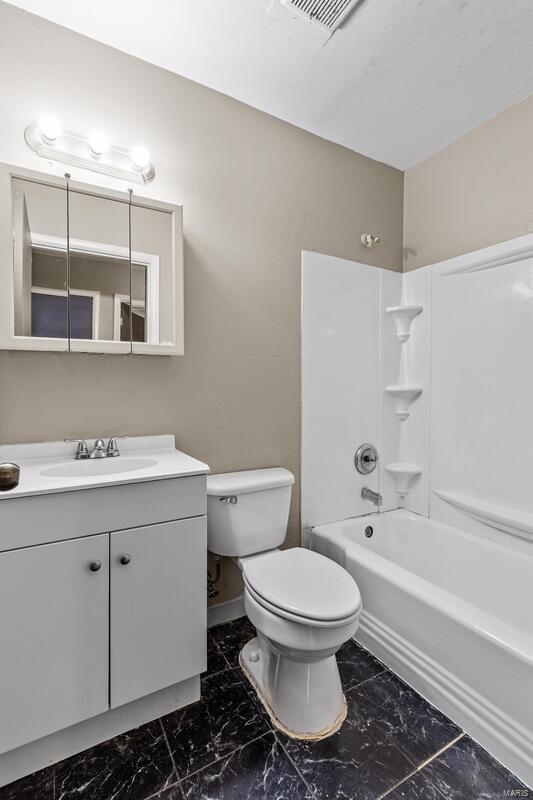 full bathroom featuring vanity, toilet, and bathtub / shower combination