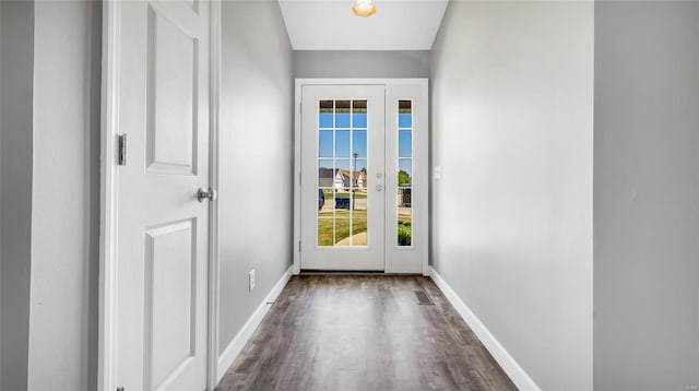 entryway with dark hardwood / wood-style flooring and a water view