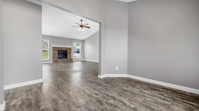 unfurnished living room with ceiling fan, a fireplace, high vaulted ceiling, and hardwood / wood-style floors