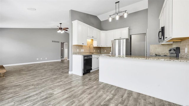 kitchen with white cabinets, stainless steel fridge, black dishwasher, and tasteful backsplash