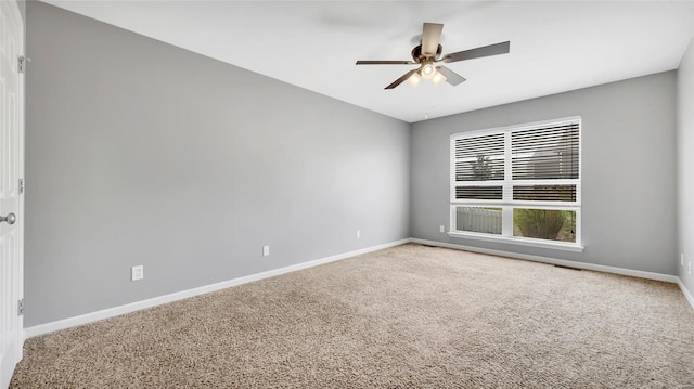 spare room featuring carpet floors and ceiling fan