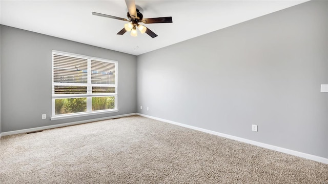 spare room featuring carpet floors and ceiling fan