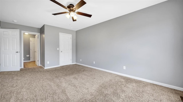 unfurnished bedroom with light colored carpet and ceiling fan