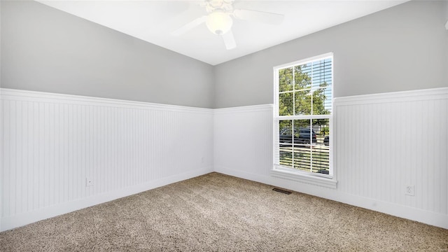 spare room featuring carpet flooring and ceiling fan