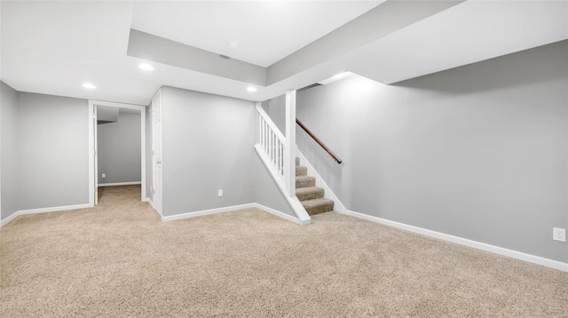 basement featuring light colored carpet