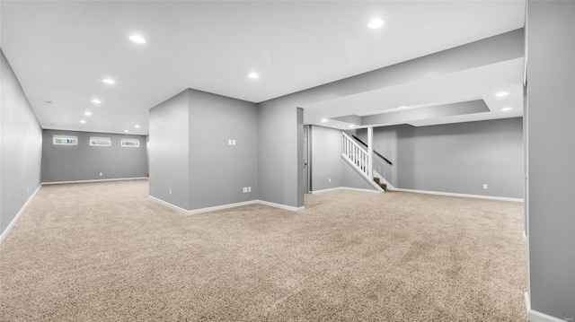 basement featuring light carpet