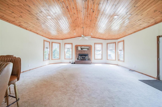 unfurnished living room featuring a fireplace, wooden ceiling, carpet flooring, ceiling fan, and vaulted ceiling