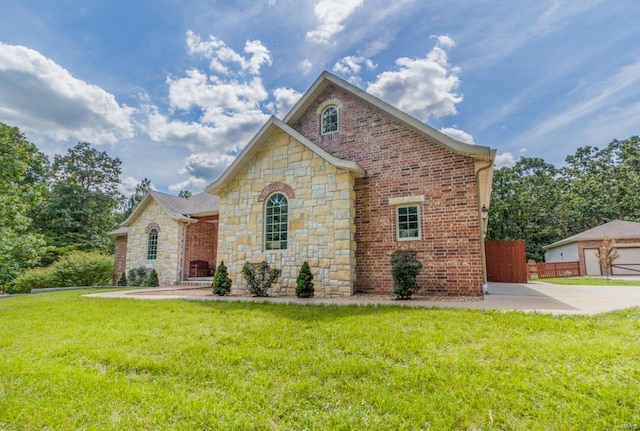 front facade featuring a garage and a front lawn