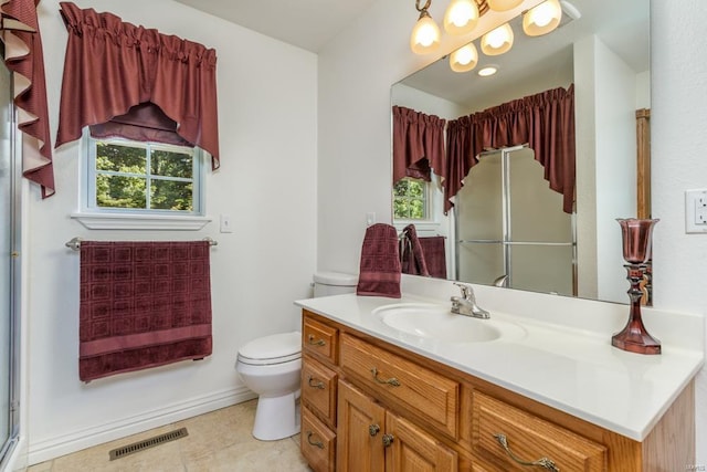 bathroom with a shower with shower door, tile patterned flooring, toilet, and vanity