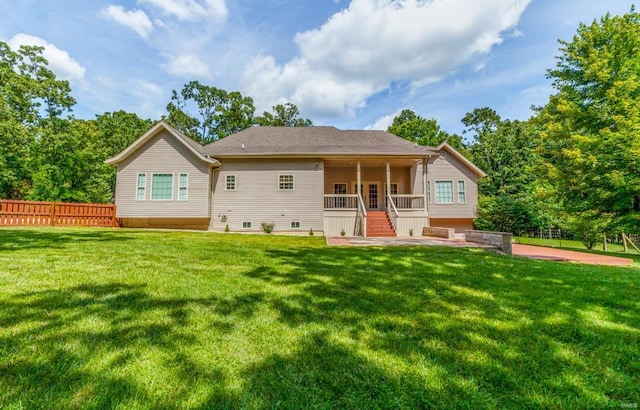 back of property featuring a yard