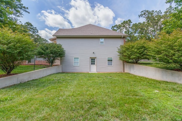 back of property featuring a lawn