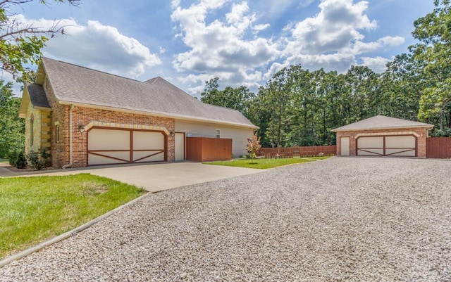 view of front of property featuring a garage and a front lawn