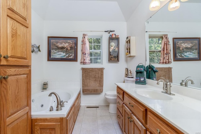 bathroom featuring vanity, tile patterned floors, a tub, and toilet