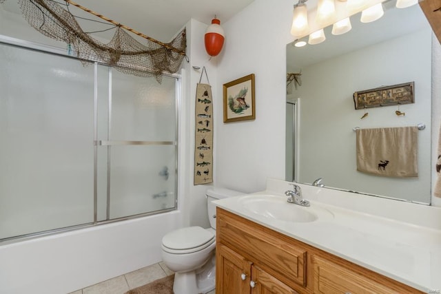 full bathroom with toilet, tile patterned floors, shower / bath combination with glass door, and vanity