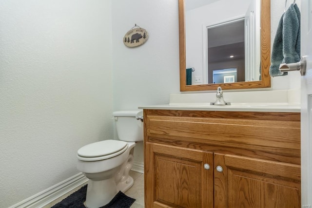 bathroom featuring vanity, toilet, and tile patterned floors