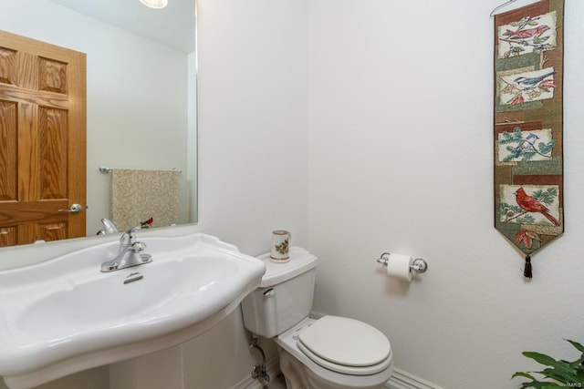 bathroom featuring toilet and sink