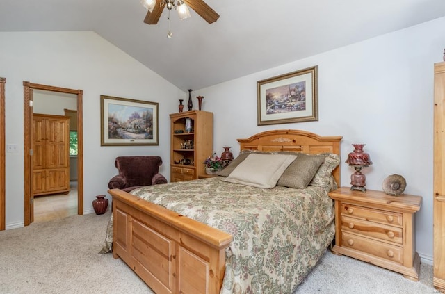 carpeted bedroom featuring ceiling fan and vaulted ceiling