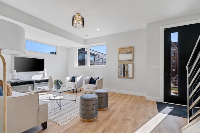 living room with light hardwood / wood-style floors and a wealth of natural light