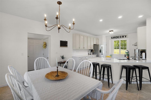 dining room with an inviting chandelier and sink