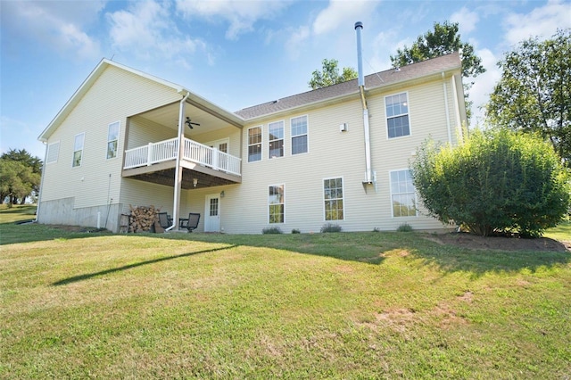 back of property featuring ceiling fan, a yard, and a balcony