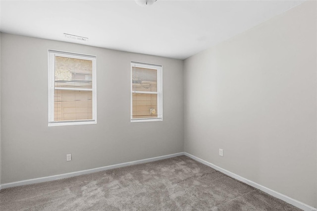 carpeted empty room with a healthy amount of sunlight