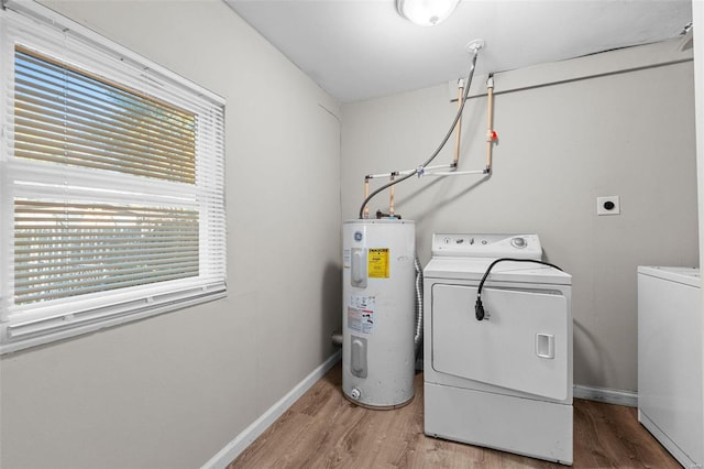 clothes washing area with wood-type flooring, water heater, and washing machine and clothes dryer