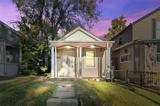 bungalow-style house featuring a lawn