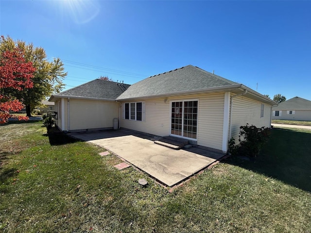 rear view of property featuring a yard and a patio area