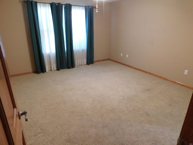 empty room featuring light carpet