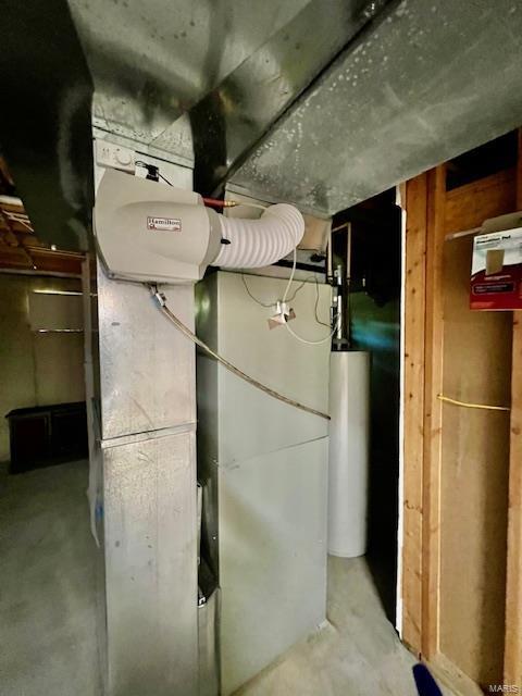 utility room featuring water heater