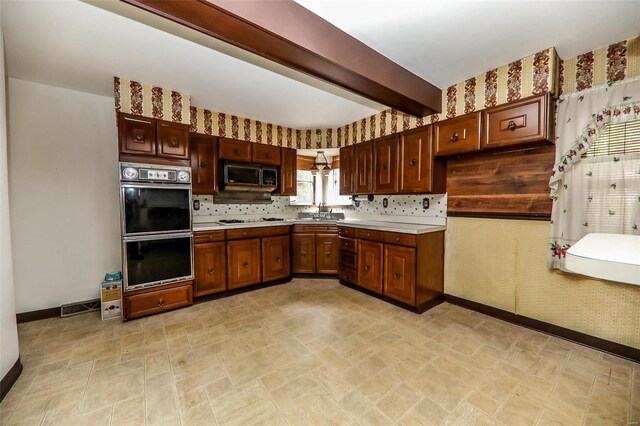 kitchen with beam ceiling, tasteful backsplash, double oven, and white gas cooktop