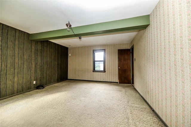 empty room with carpet and wooden walls