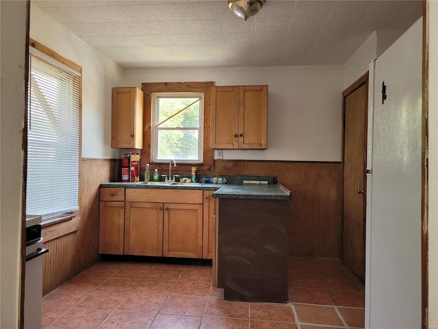 kitchen with sink, dark tile patterned floors, and wall oven