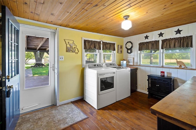 laundry area featuring washing machine and dryer, a wealth of natural light, wood ceiling, and dark hardwood / wood-style floors