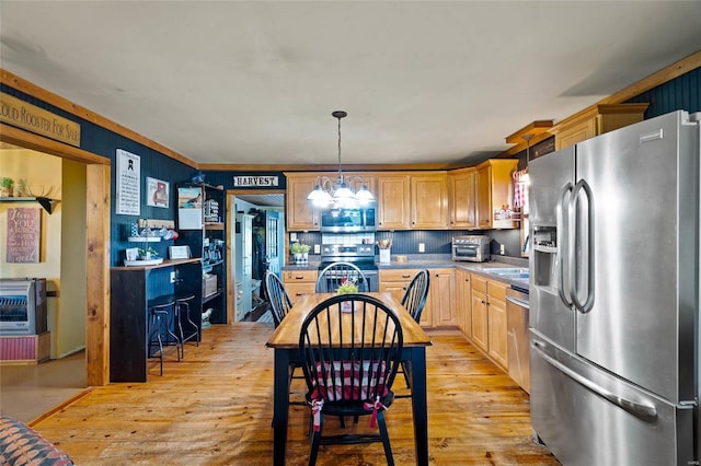 kitchen featuring stainless steel appliances, an inviting chandelier, light hardwood / wood-style floors, decorative light fixtures, and light brown cabinetry