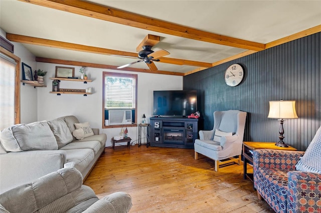 living room featuring cooling unit, ceiling fan, beamed ceiling, and light hardwood / wood-style floors