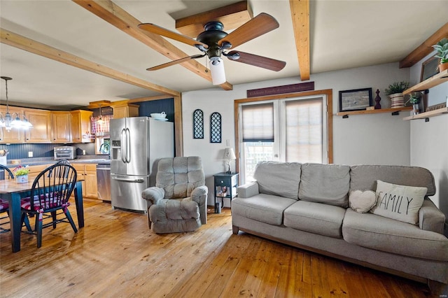 living room with beam ceiling, ceiling fan, sink, and light wood-type flooring