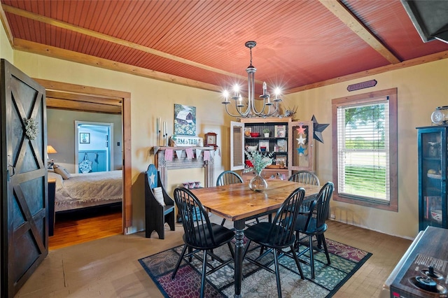 dining room with light hardwood / wood-style floors, wood ceiling, and an inviting chandelier