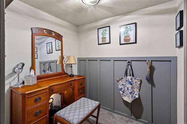 sitting room with carpet and a textured ceiling