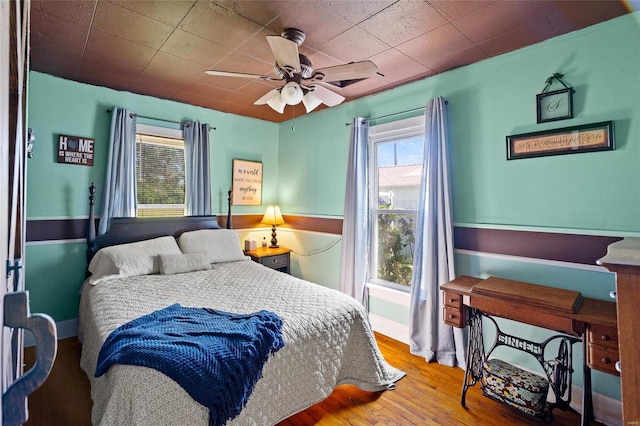 bedroom featuring hardwood / wood-style flooring and ceiling fan