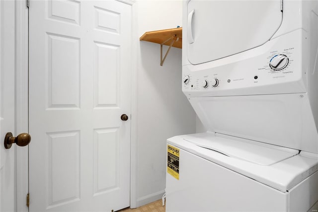 clothes washing area featuring stacked washer and dryer