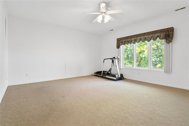 carpeted empty room featuring ceiling fan