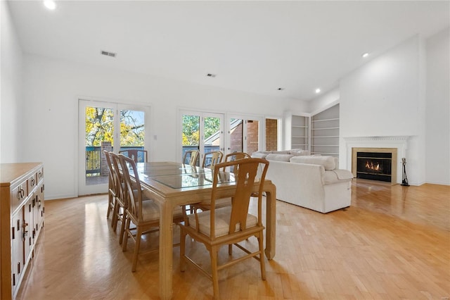 dining room with built in features and light wood-type flooring