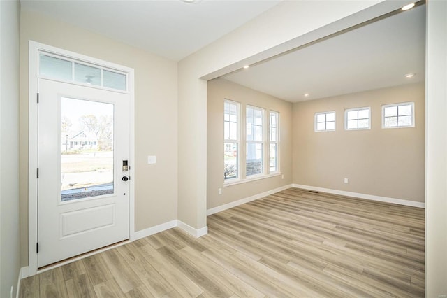 foyer entrance with light wood-type flooring