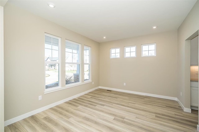 spare room featuring light hardwood / wood-style floors