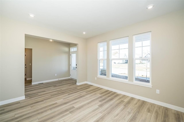 spare room featuring light hardwood / wood-style flooring