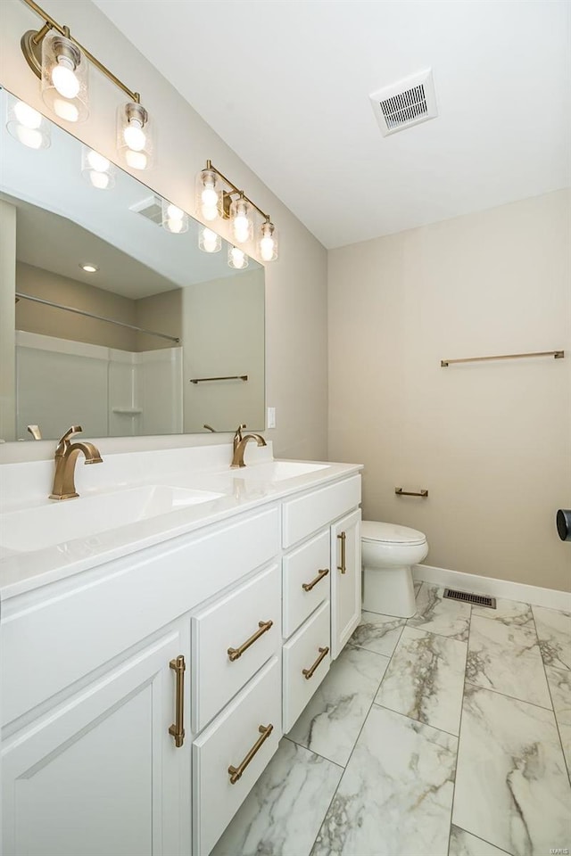 bathroom featuring a shower, vanity, and toilet