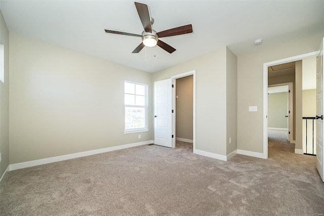 unfurnished bedroom featuring ceiling fan and light carpet