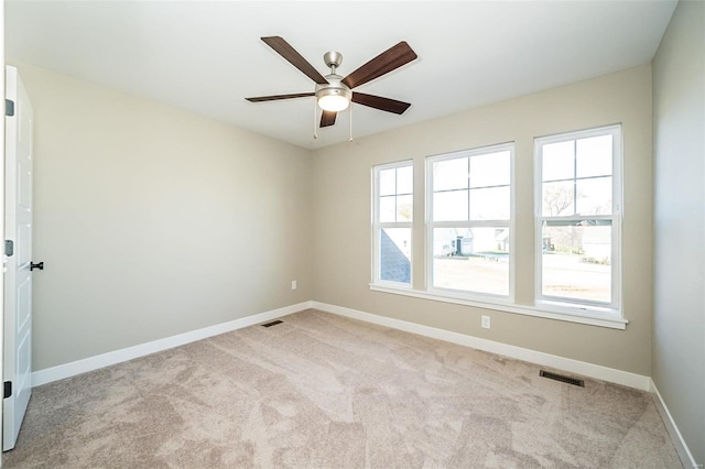 empty room with ceiling fan and light colored carpet