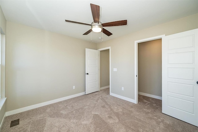 unfurnished bedroom with ceiling fan and light colored carpet